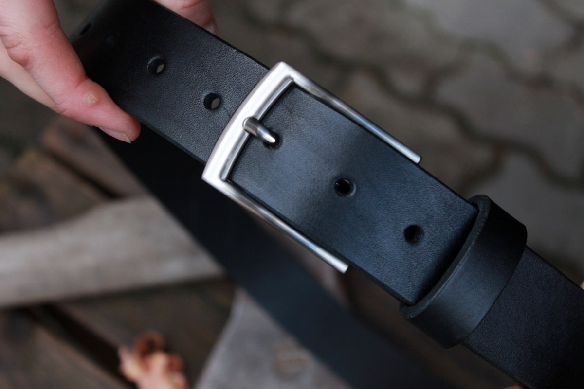 Black leather belt with silver buckle.
